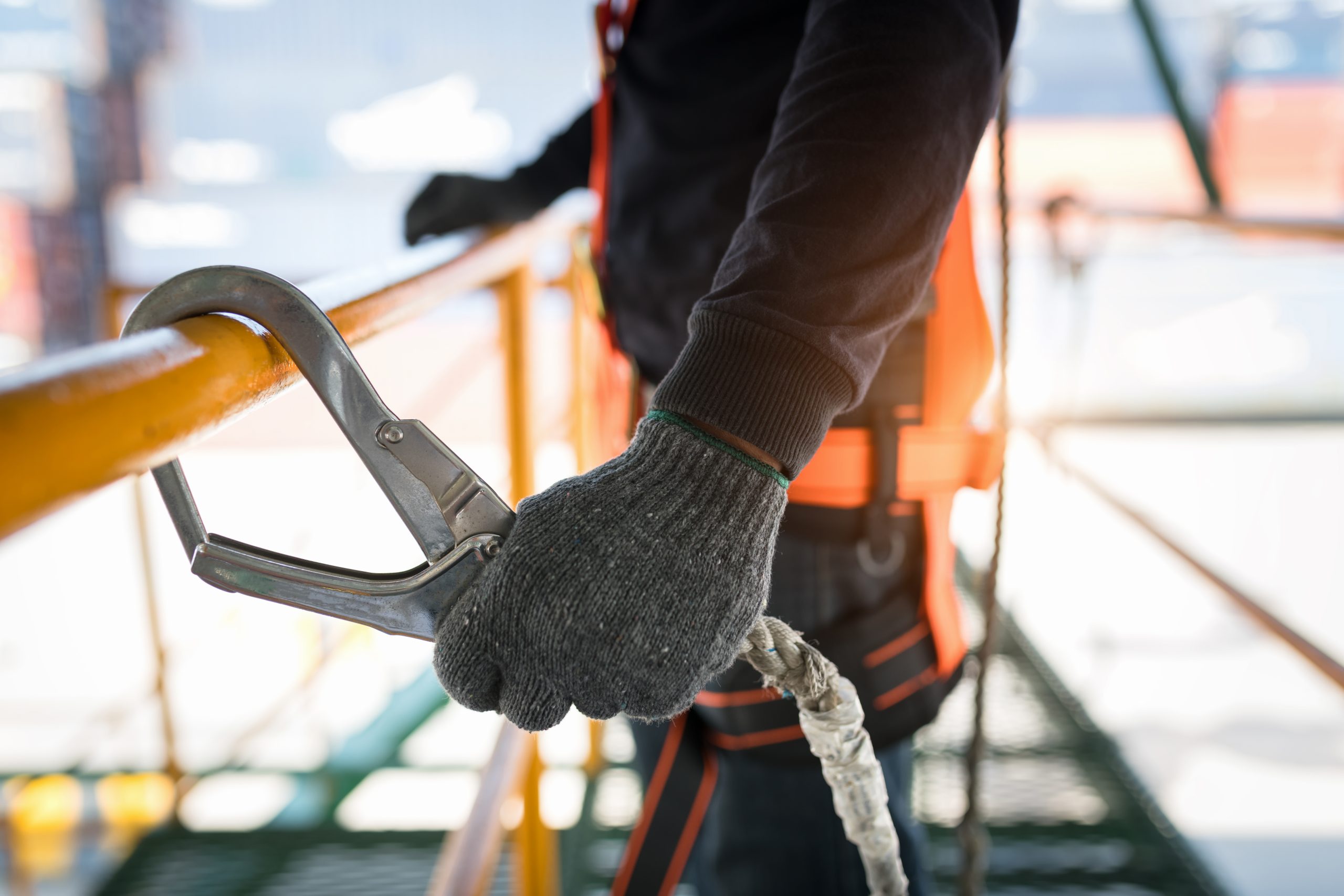 Construction worker wearing safety harness and safety line